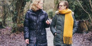 two women walking in the forest